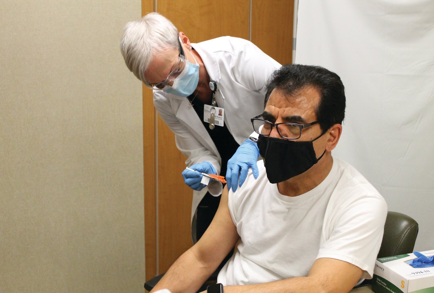 Sarah Wuellner, RN, of the Infection Control Department at Bothwell Regional Health Center, gives Dr. Assad Shaffiey, of Bothwell TLC Pediatrics, one of the first COVID-19 vaccines in Sedalia on Dec. 18, 2020, at Bothwell.