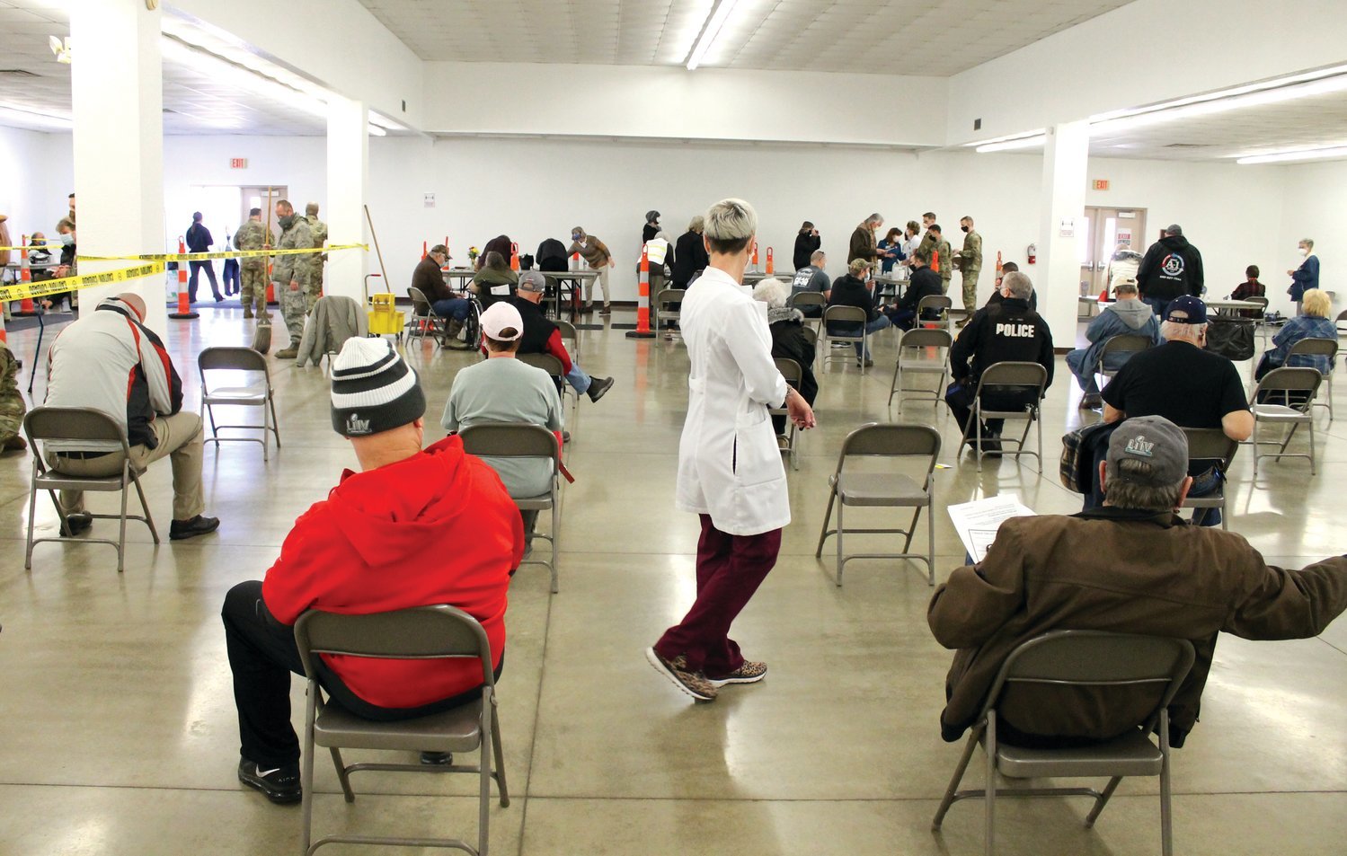 Sarah Wuellner, RN, of the Infection Control Department at Bothwell Regional Health Center, walks through the rows of seated citizens who are waiting in the observation area after receiving their vaccine Jan. 28 in the MO-Ag Theatre on the Missouri State Fairgrounds during a mass vaccination event. Everyone was required to wait 15 minutes before leaving.