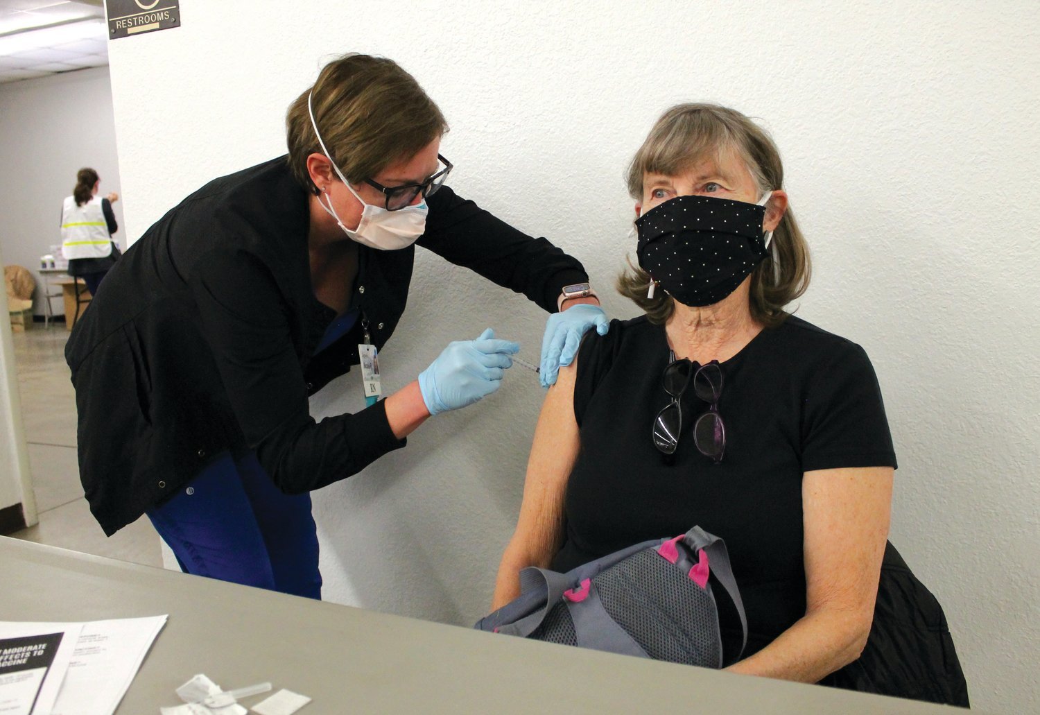 Nicole Porter, RN, of Bothwell Regional Health Center, administers a COVID-19 vaccine to Sandy Fracchia, of Sedalia, on Jan. 28 at the MO-AG Theatre on the Missouri State Fairgrounds during a mass vaccination event. “I get the flu shot every year and I figured I’d get this too,” Fracchia said. “I have people to see and a life to live again.”
