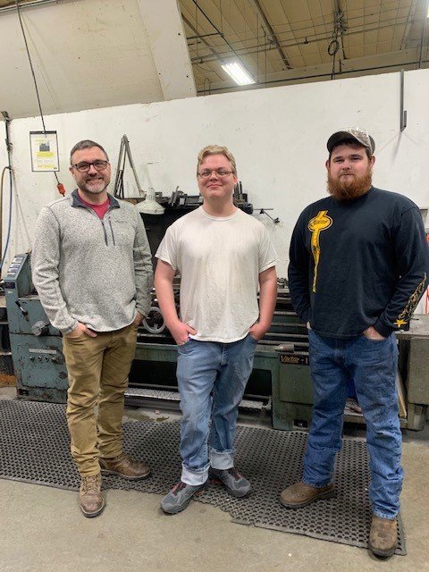 SFCC’s Work Experience Week students and employees at Starline Brass are, from left, SFCC instructor Justin Wright, student Sean McCormick, and Starline machinist Dusty McCubbins.