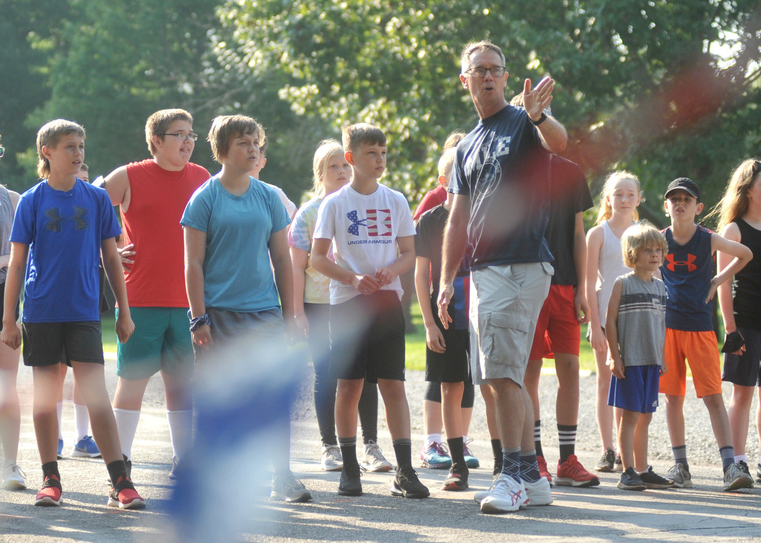 Jeff Mittelhauser directs runners before the 14-and-under race Sunday at the Firecracker Mile at Liberty Park in Sedalia.
