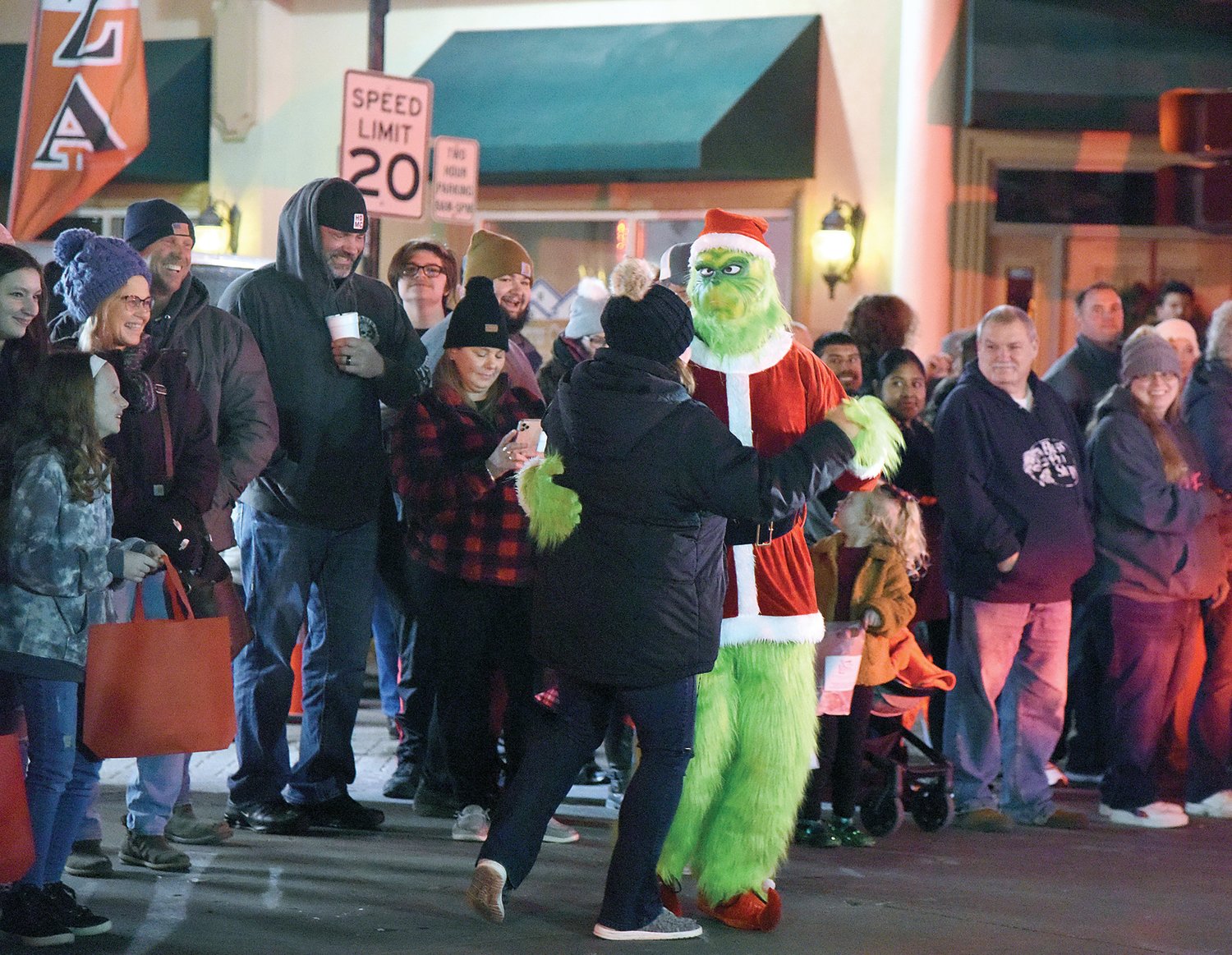 The “Grinch” dances with a woman along Ohio Avenue, during the annual Christmas Parade, Saturday, in downtown Sedalia.