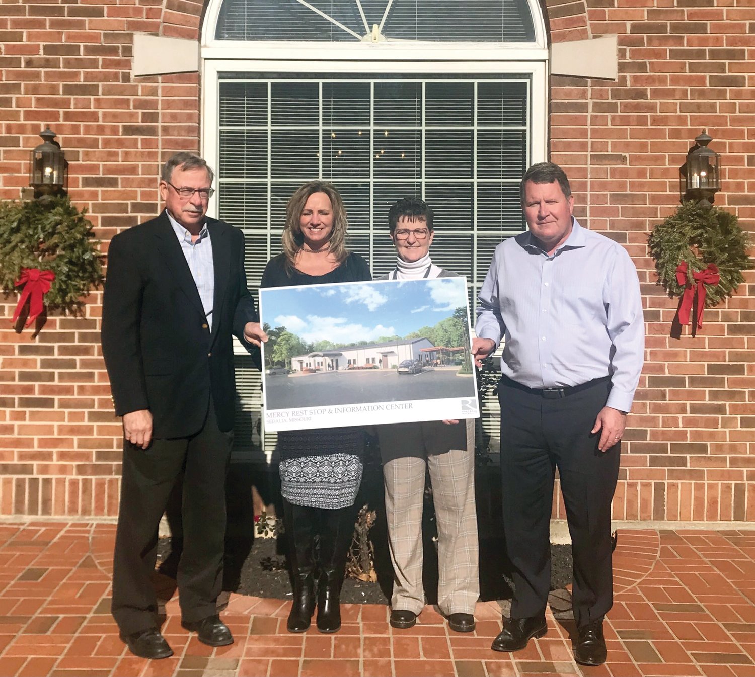 The Buckley & Buckley Law Firm, of Sedalia, recently supported the construction of Mercy Rest Stop through a financial contribution of $5,000 and legal services. From left are Bill Turner, chair of the Mercy Rest Stop board, and Kim Nusser, Debbie Ulmer and Jim Buckely of the law firm, holding a rendering of the Mercy Rest Stop facility.