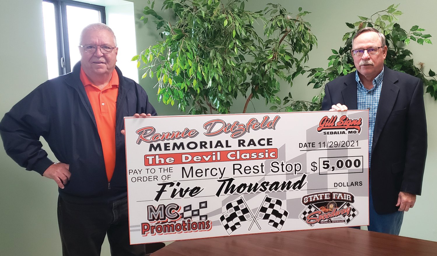 MC Promotions, operated by Larry McCown and Randy Combs, hosted the Ron Ditzfeld Memorial Race on July 29 at the Missouri State Fair Speedway. McCown, left, presents a $5,000 check to Bill Turner toward the construction of Mercy Rest Stop. Turner is the chair of the Mercy Rest Stop board.