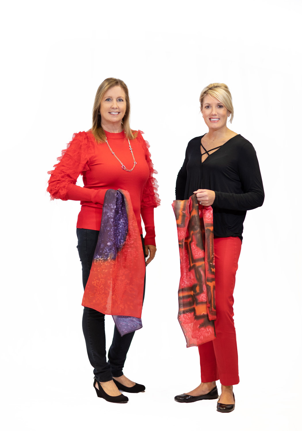 Wear Red for Women committee members model silk scarves custom-made by State Fair Community College art students that will be available to bid on at the Bothwell Foundation’s annual luncheon event.