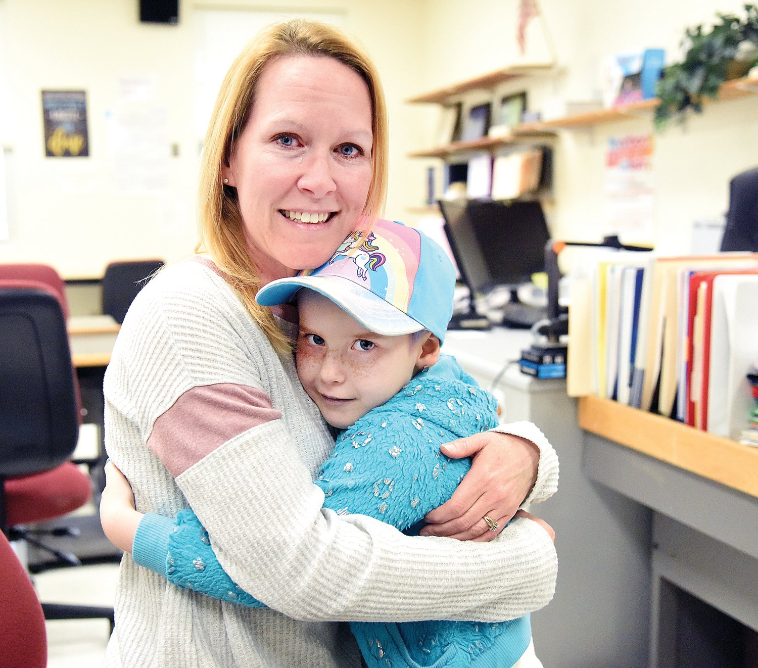 Green Ridge kindergarten teacher Jill Piscopo cries tears of joy at a surprise visit Tuesday by her student Chevi Meyers, 5, who has stage four cancer. Chevi hasn’t been able to attend school due to her illness and its treatment. A fundraiser is planned for Chevi on April 23.
