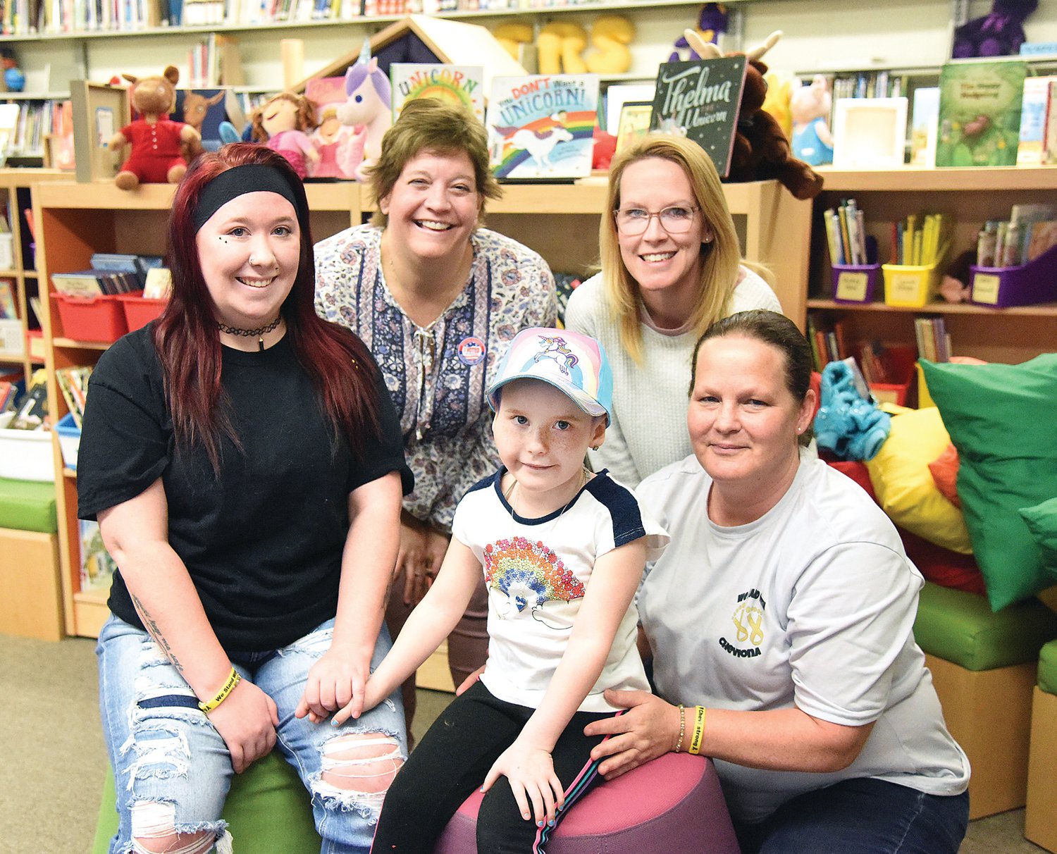 Posing for a photo in the Green Ridge School library on Tuesday are Chevi Meyer, 5, and from left her mother Destiny Strickland, STEAM teacher and librarian Nancey Dove, kindergarten teacher Jill Piscopo, and grandmother Julie Meyer. Chevi is known for her smile and freckles, and her love of unicorns and gold stars.