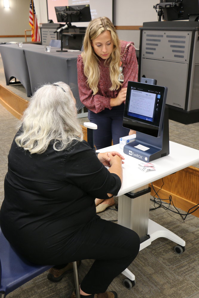 Lindsey Graham, certified physician assistant at Bothwell Orthopedics & Sports Medicine, performs a demo on the new EyeBOX concussion assessment device with an attendee at Bothwell’s Athletic Injury Conference recently held at State Fair Community College.