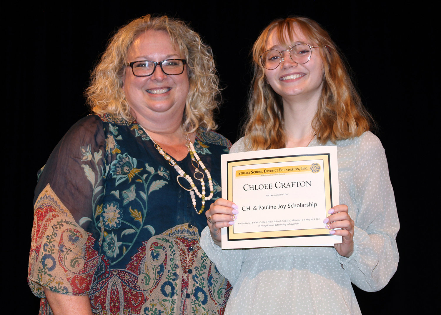 Smith-Cotton High School Counselor Pam Crafton, left, presents her granddaughter, Chloee, the C.H. & Pauline Joy Scholarship during Senior Awards Night on May 4 in the Heckart Performing Arts Center. Pam Crafton died unexpectedly on Monday, Sept. 26.